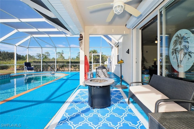 view of pool with a lanai, a patio area, and an outdoor fire pit