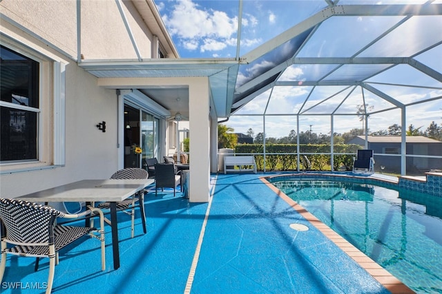 view of swimming pool featuring a patio and glass enclosure