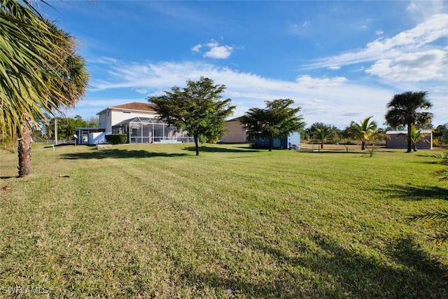 view of yard with a lanai