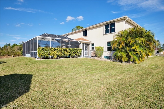 back of property with a lanai and a yard