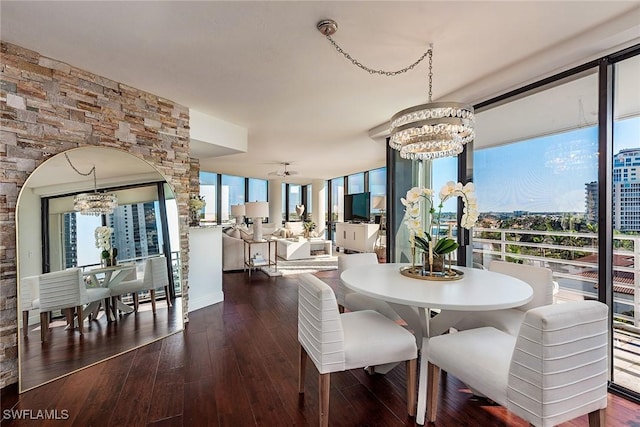 dining area featuring an inviting chandelier, dark hardwood / wood-style flooring, and floor to ceiling windows