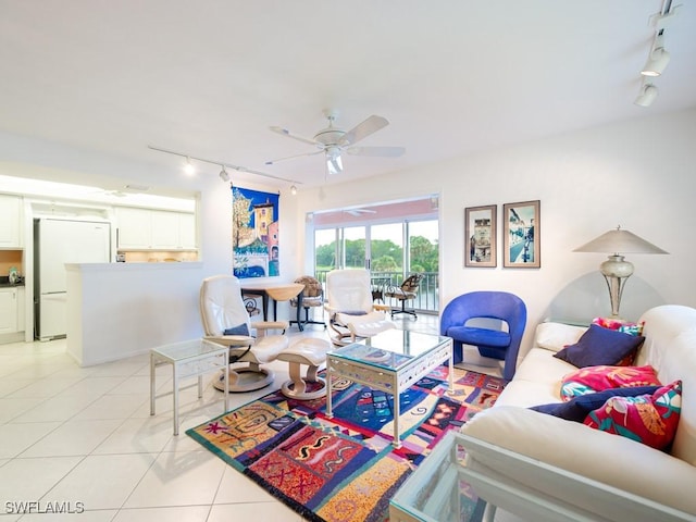 tiled living room with track lighting and ceiling fan