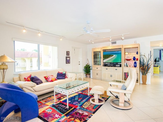 tiled living room featuring rail lighting and ceiling fan