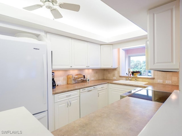 kitchen with tasteful backsplash, white cabinetry, sink, ceiling fan, and white appliances