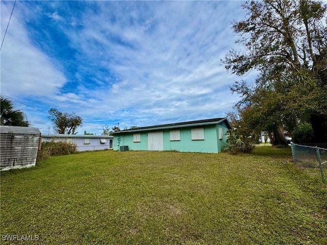 rear view of property with a yard