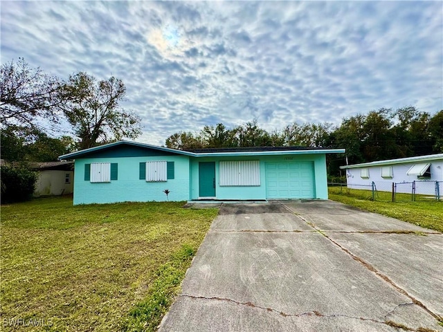 single story home featuring a garage and a front lawn