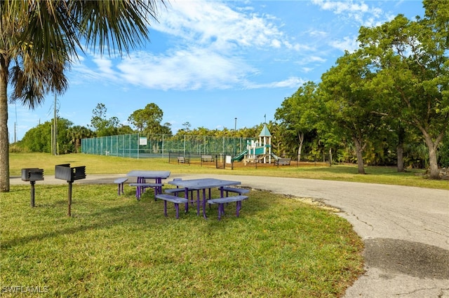 surrounding community with a playground and a lawn