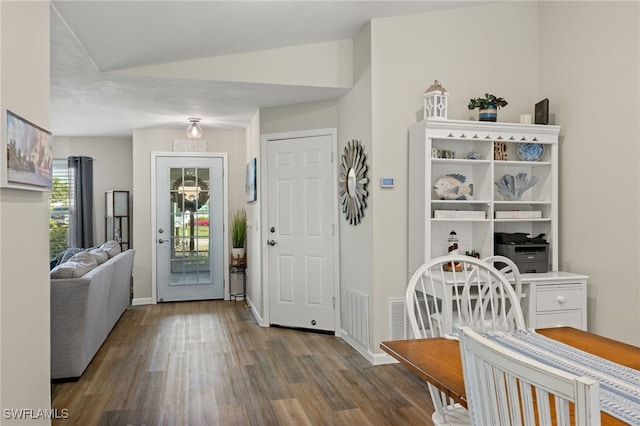 foyer entrance with visible vents, baseboards, and wood finished floors