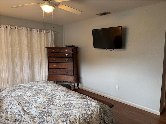 bedroom featuring dark wood-type flooring and ceiling fan