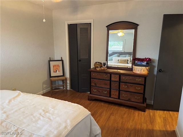 bedroom with wood-type flooring and a closet