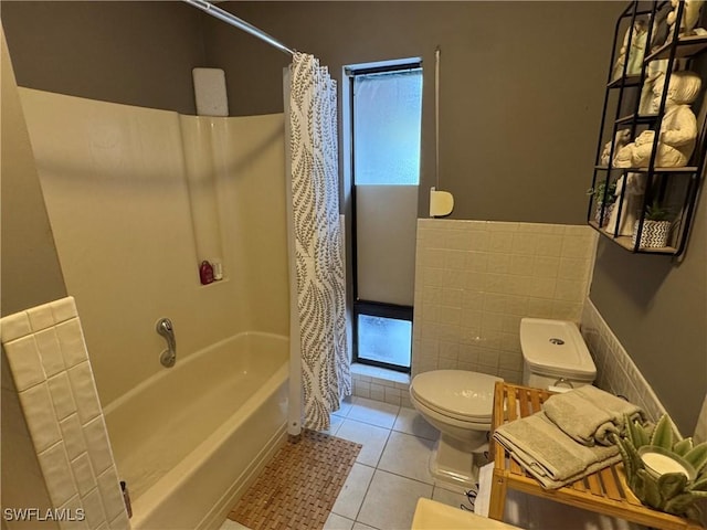 bathroom with tile walls, tile patterned flooring, toilet, and shower / tub combo with curtain