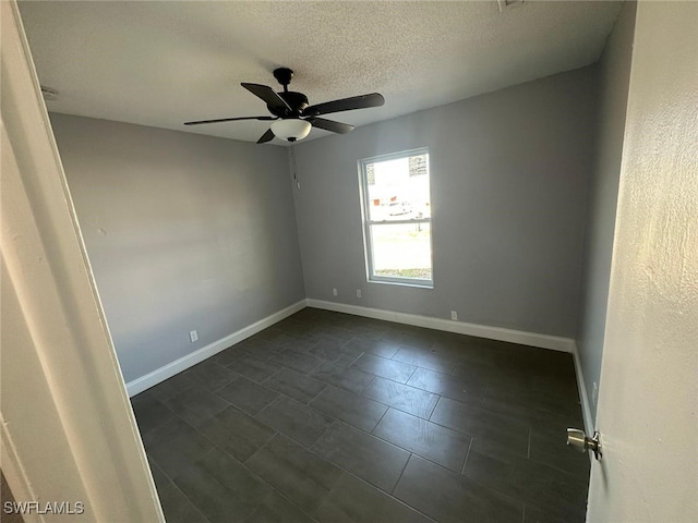 empty room featuring ceiling fan and a textured ceiling