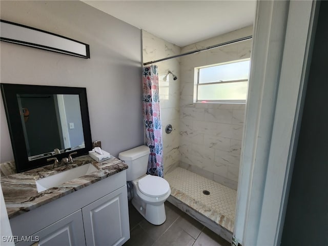 bathroom featuring vanity, toilet, curtained shower, and tile patterned floors