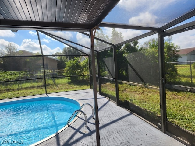 view of pool with a lanai and a patio