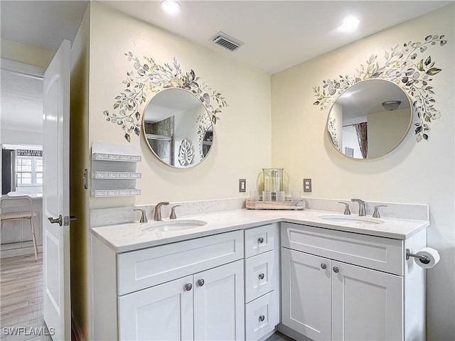 bathroom with hardwood / wood-style floors and vanity