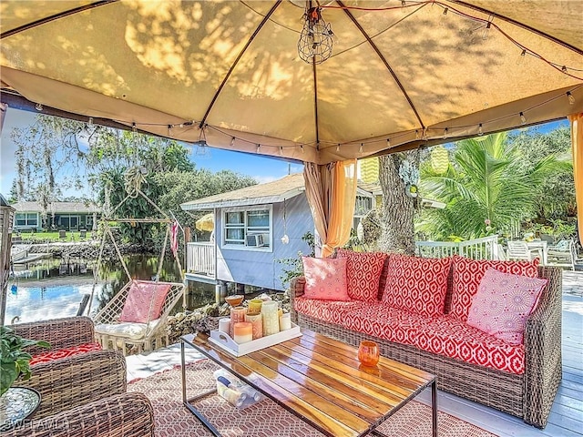 view of patio / terrace featuring a gazebo, a water view, and outdoor lounge area