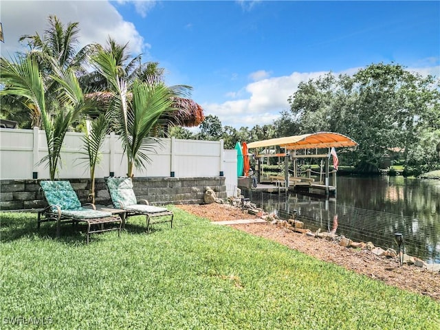 view of yard with a dock and a water view