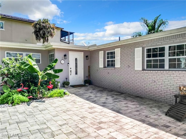 doorway to property with a patio area