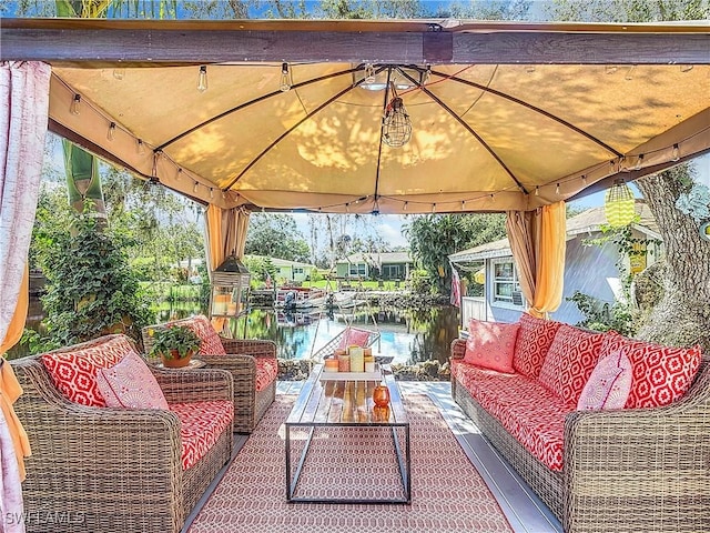 view of patio / terrace featuring a gazebo, an outdoor living space, and a water view