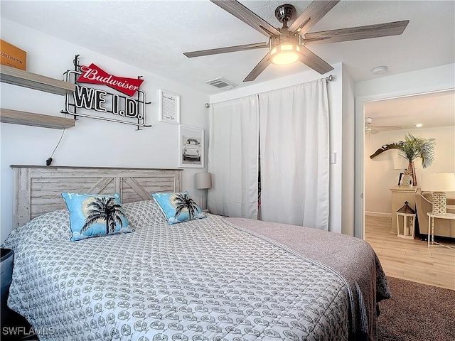 bedroom with ceiling fan and hardwood / wood-style floors