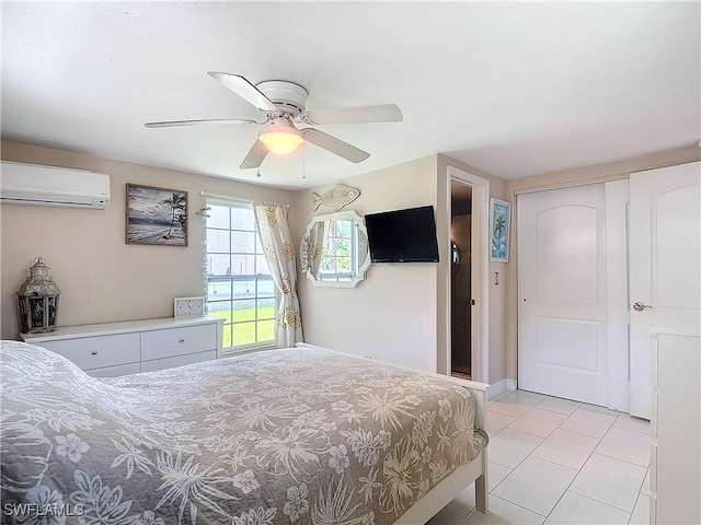 bedroom with a closet, ceiling fan, an AC wall unit, and light tile patterned flooring