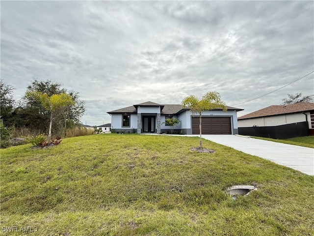 view of front of house featuring a garage and a front lawn