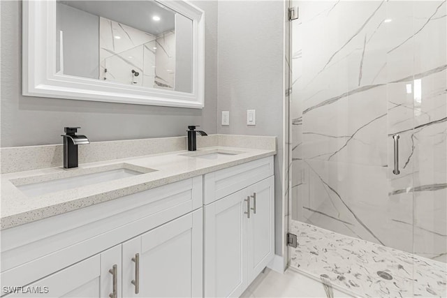 bathroom with an enclosed shower and vanity