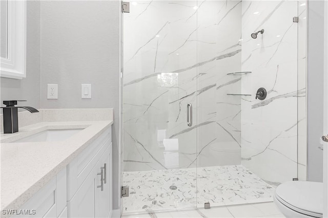 bathroom featuring vanity, toilet, and walk in shower