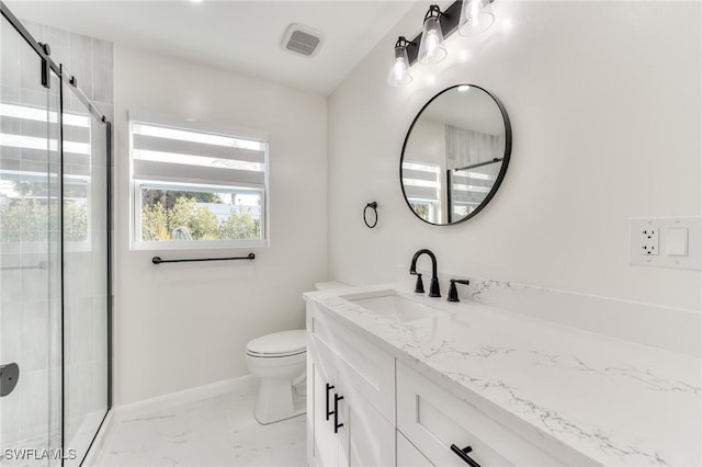 bathroom with vanity, a shower with shower door, and toilet