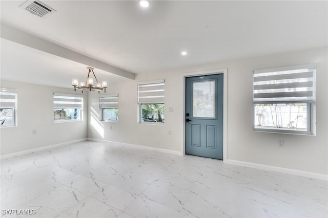 entryway with a chandelier