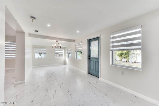 foyer entrance with an inviting chandelier