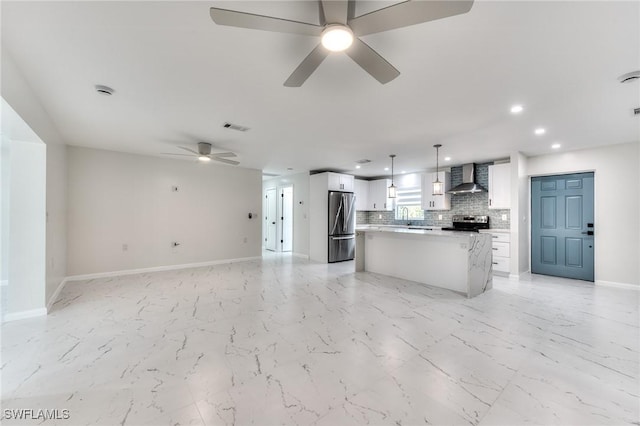 unfurnished living room with sink and ceiling fan