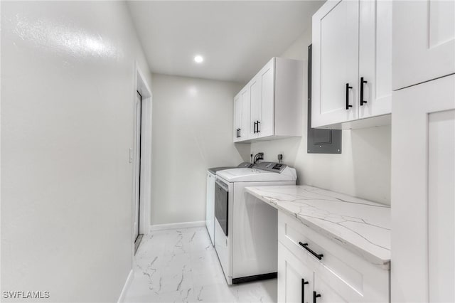 laundry room with cabinets and separate washer and dryer