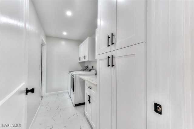 laundry room featuring cabinets and independent washer and dryer