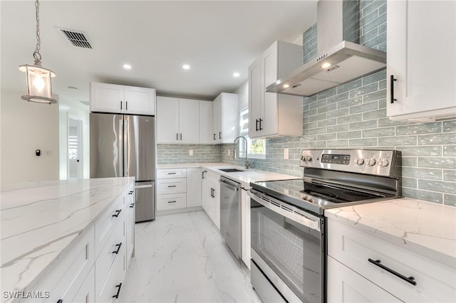 kitchen featuring appliances with stainless steel finishes, wall chimney range hood, white cabinets, sink, and light stone counters