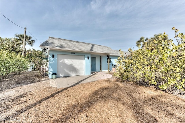 back of house featuring a garage