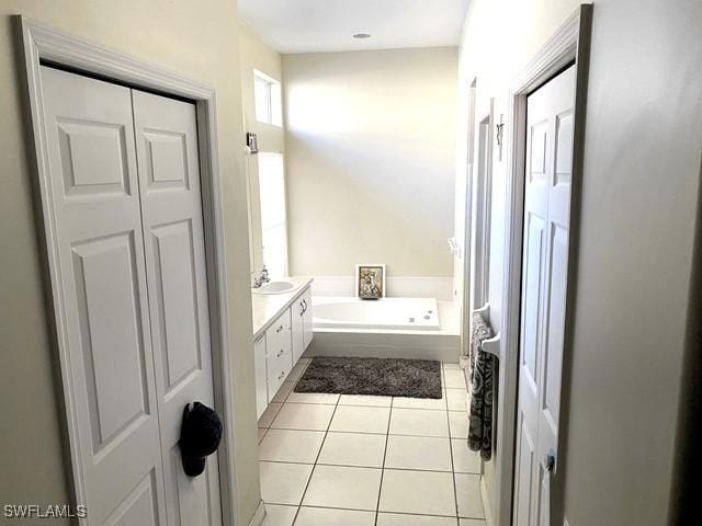 bathroom featuring vanity, tile patterned floors, and a bathtub