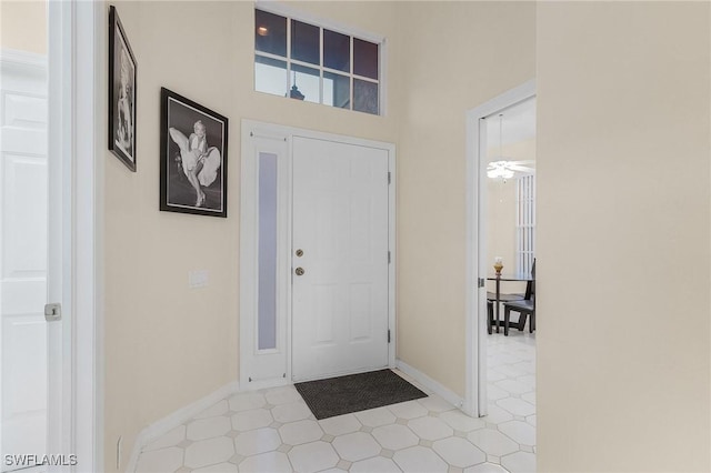 entrance foyer with tile patterned floors and baseboards