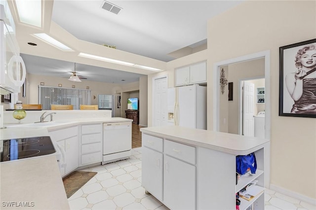 kitchen with visible vents, light countertops, white appliances, and light floors