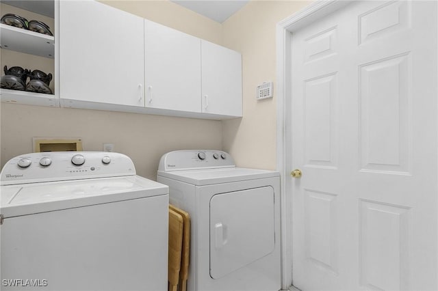 laundry area with washer and clothes dryer and cabinet space