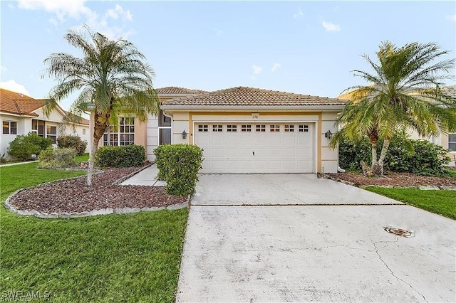 view of front of property featuring an attached garage, a tiled roof, driveway, and stucco siding