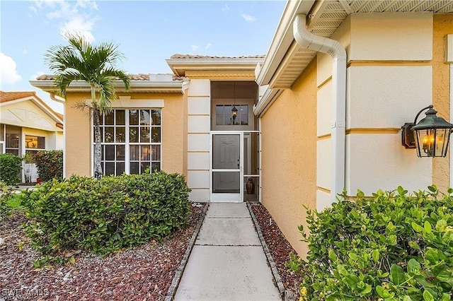 entrance to property with stucco siding