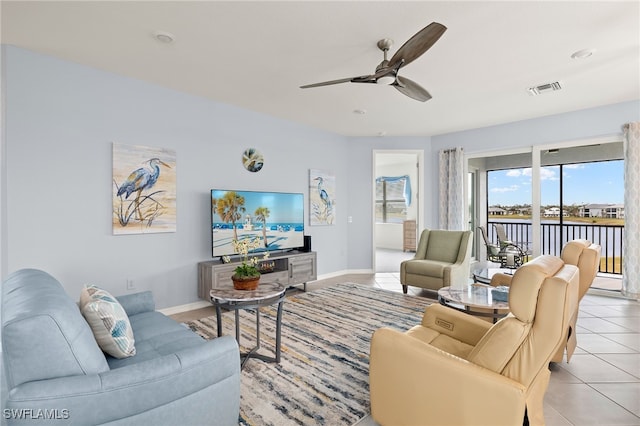 tiled living room with ceiling fan