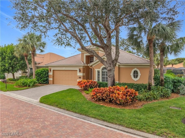 mediterranean / spanish home with a garage and a front yard