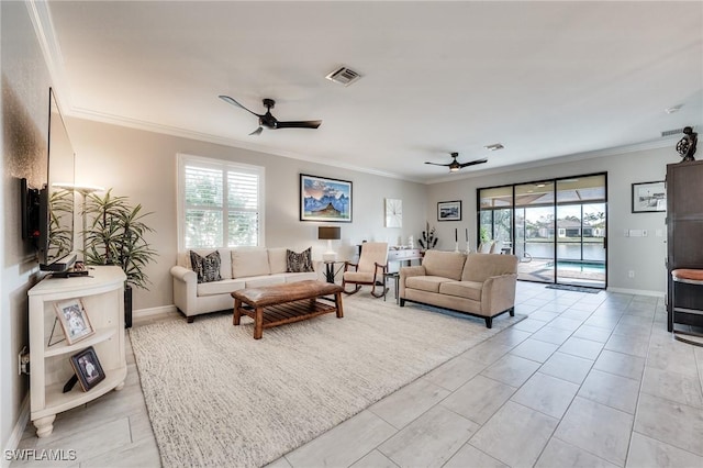 tiled living room with ornamental molding and ceiling fan