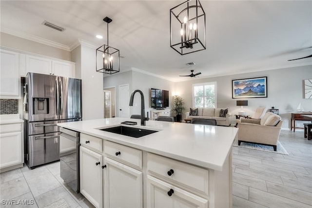 kitchen featuring sink, white cabinetry, a center island with sink, stainless steel fridge, and dishwashing machine