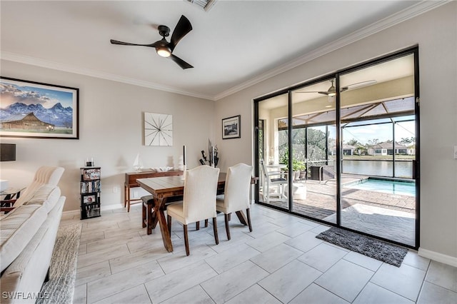 dining room featuring crown molding, a water view, and ceiling fan