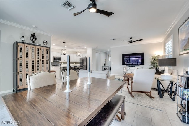 dining room with crown molding and ceiling fan