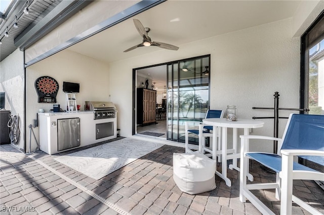 view of patio / terrace with exterior kitchen, grilling area, and ceiling fan