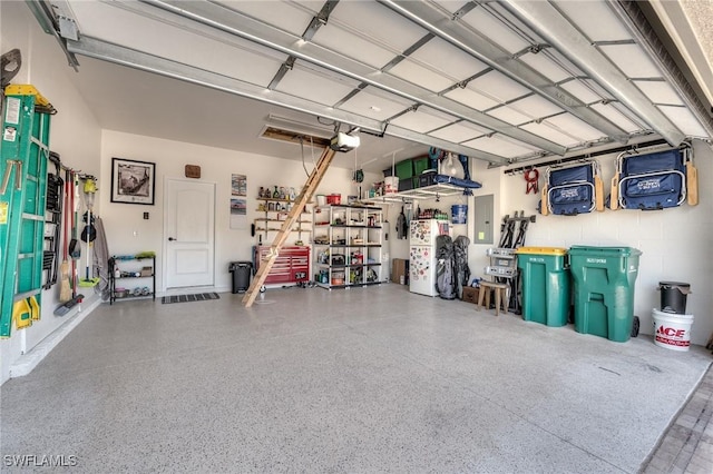 garage with a garage door opener and electric panel